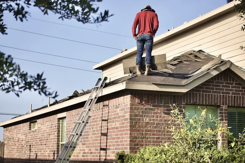 Professional roofer working on a residential roof in Cameo